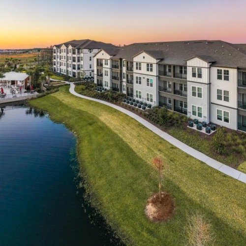 Find your perfect fit at Sonceto Apartments a row of buildings next to a body of water